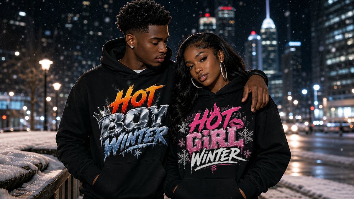 Models wearing Hot Boy Winter and Hot Girl Winter hoodies on a snowy city street at night